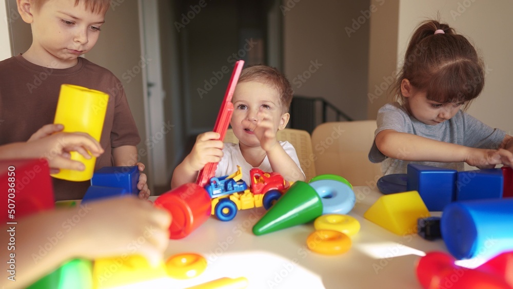 kindergarten. a group of children play toys cubes and cars on the table in kindergarten. kid dream creative happy family preschool lifestyle education concept. nursery baby toddler home kindergarten. a group of children play toys cubes and cars on the table in kindergarten. kid dream creative happy family preschool lifestyle education concept. nursery baby toddler home