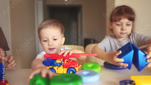 kindergarten. a group of children play toys cubes and cars on the table in kindergarten. kid dream creative lifestyle happy family preschool education concept. nursery baby toddler home