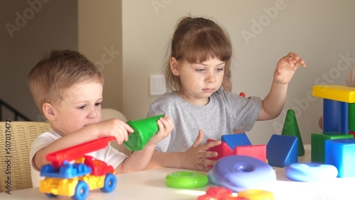 kindergarten. a group of children play toys cubes and cars on the table in kindergarten. kid dream creative happy family preschool education concept. nursery baby toddler home indoor