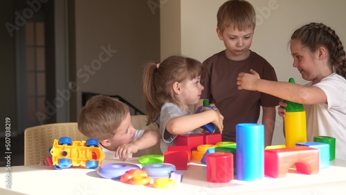 kindergarten. a group of children play toys cubes and cars indoor on the table in kindergarten. kid dream creative happy family preschool education concept. nursery baby toddler home