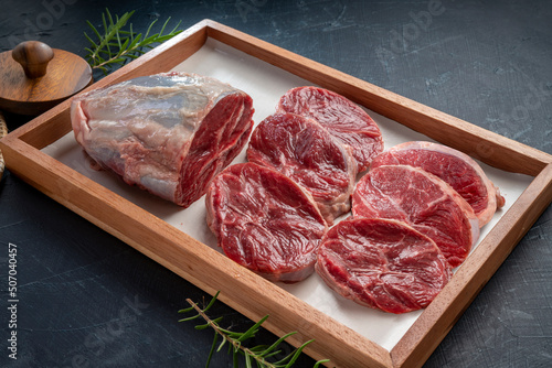 Fresh Silver shank meat in wooden plate on wooden background, Shank beef first grade in wooden plate on wooden background.	