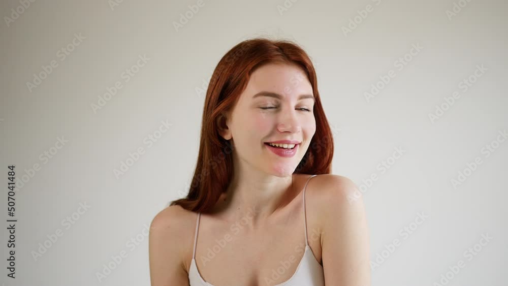 Young beautiful happy girl playfully winks at the camera. Young beautiful happy girl playfully winks at the camera.