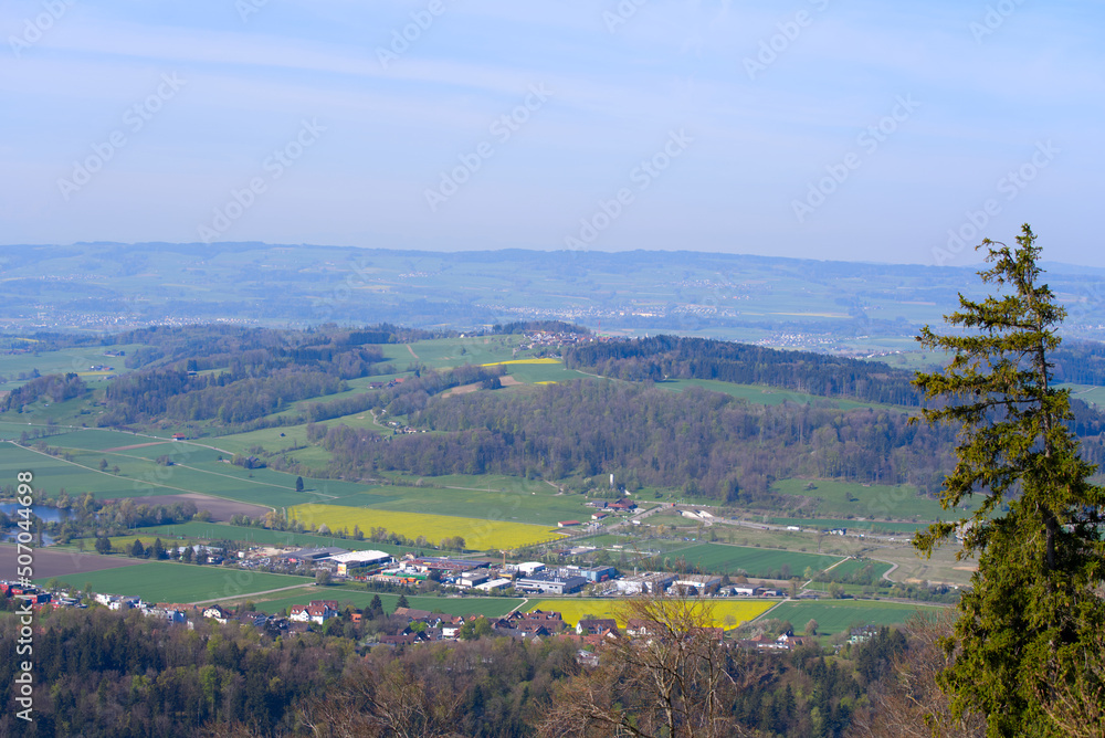 Aerial view over rural landscape seen from local mountain Uetliberg on a blue cloudy spring day. Photo taken April 21st, 2022, Zurich, Switzerland.