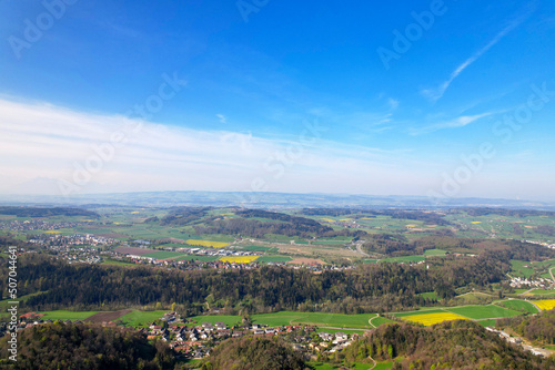 Aerial view over rural landscape seen from local mountain Uetliberg on a blue cloudy spring day. Photo taken April 21st, 2022, Zurich, Switzerland.