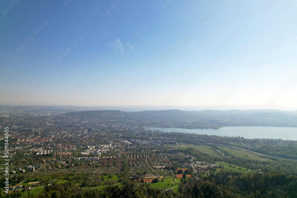 Aerial view over City of Zürich with bay of Lake Zürich on a beautiful spring day with blue cloudy sky background. Photo taken April 21st, 2022, Zurich, Switzerland.