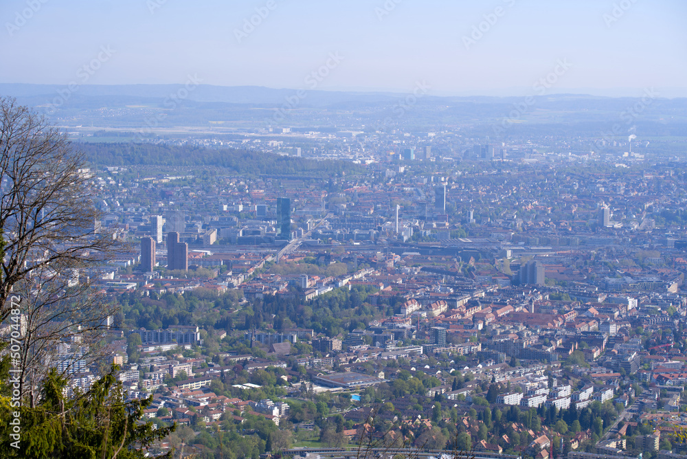 Aerial view over City of Zürich on a beautiful spring day with blue cloudy sky background. Photo taken April 21st, 2022, Zurich, Switzerland.