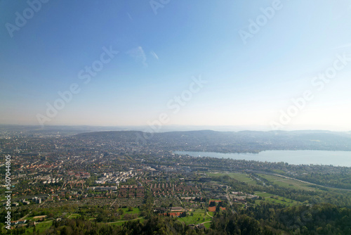 Aerial view over City of Zürich with bay of Lake Zürich on a beautiful spring day with blue cloudy sky background. Photo taken April 21st, 2022, Zurich, Switzerland.