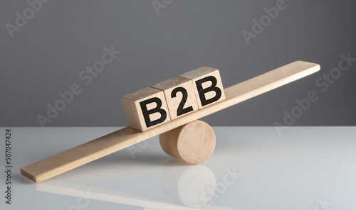 B2B on wooden cubes on a wooden balance , business concept © Iryna