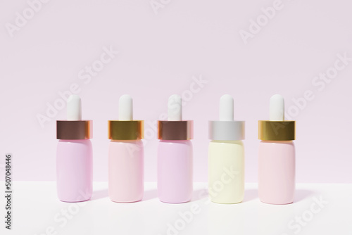 3d render of pastel colored serum pipette bottles on a pink background