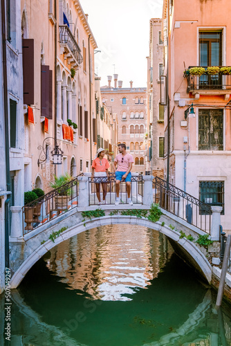 Venice Italy couple men and woman on a city trip at Venice, men and woman at waterfront Italy