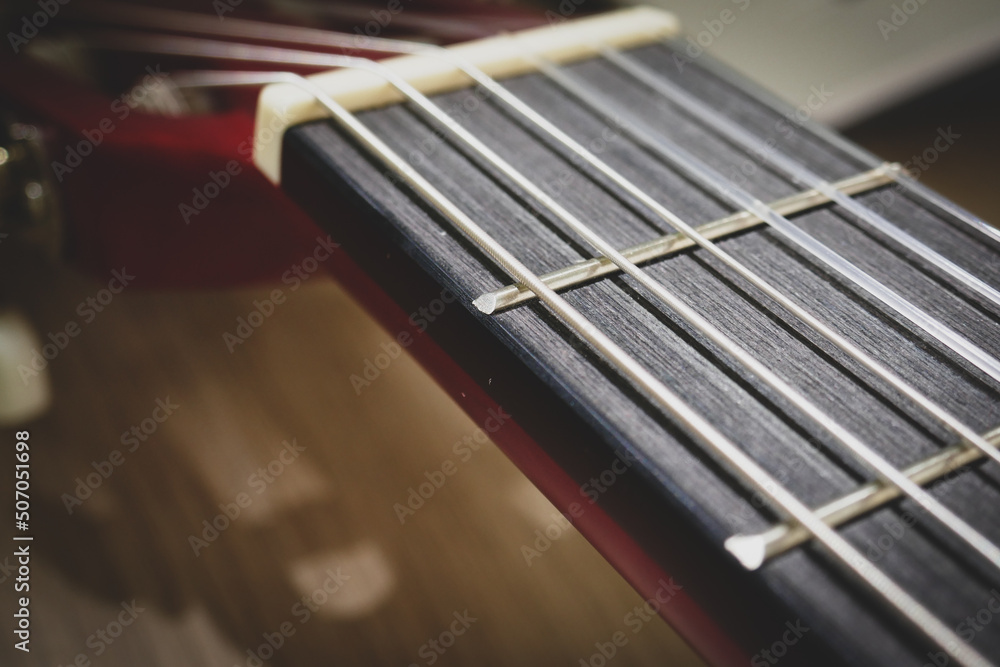 Classical guitar close up. Acoustic guitar background, strings, frets, pegs. Classical guitar close up. Acoustic guitar background, strings, frets, pegs.