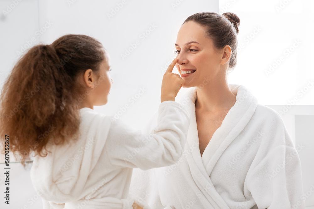 beauty, hygiene, morning and people concept - happy smiling mother and daughter having fun in at bathroom beauty, hygiene, morning and people concept - happy smiling mother and daughter having fun in at bathroom