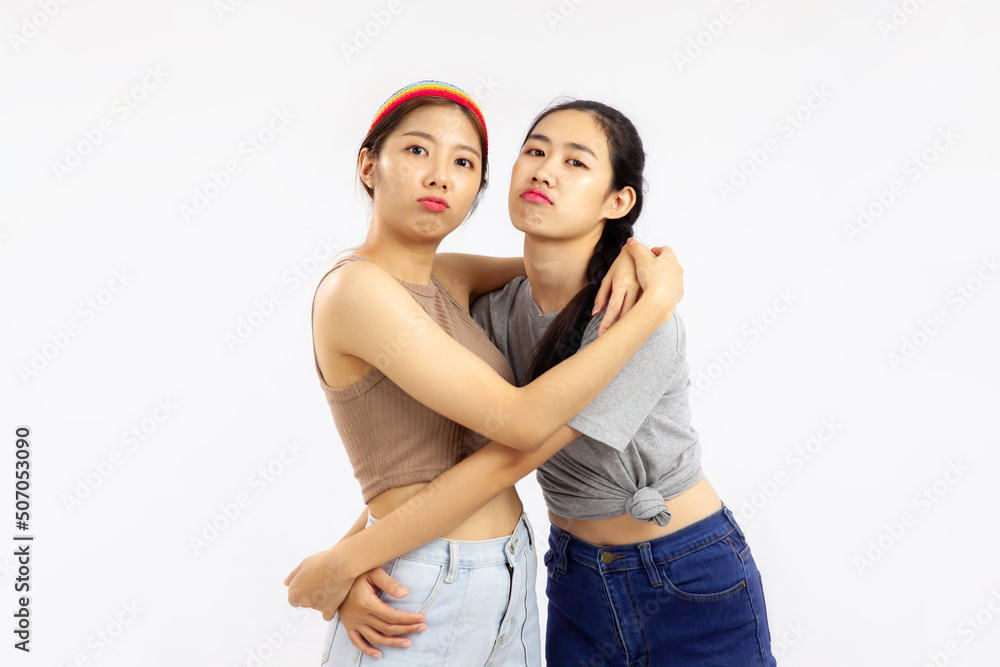 Photo of Young asian women in concept of lgbt couple isolated on white background. Photo of Young asian women in concept of lgbt couple isolated on white background.