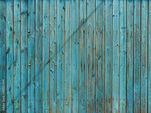 Background of blue wooden fence made of planks.