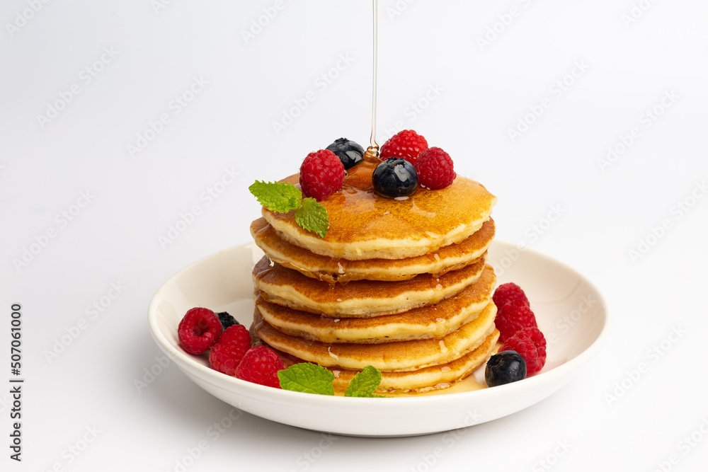 Delicious pancakes with raspberry and blueberry on White background Delicious pancakes with raspberry and blueberry on White background