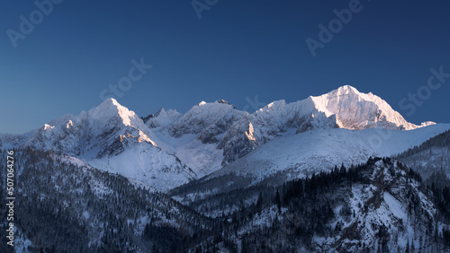 Fototapeta Naklejka Na Ścianę i Meble -  Beautiful rocky mountains with snow. Panorama of winter mountains. Sunset mountains
