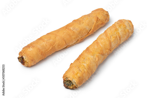 Fresh baked Turkish Spinach and feta stuffed rolls, called Borek, close up for a snack isolated on white background