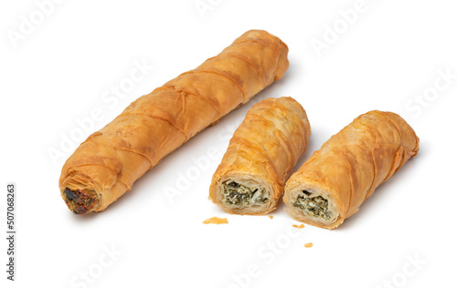 Fresh baked Turkish Spinach and feta stuffed rolls, called Borek, close up isolated on white background