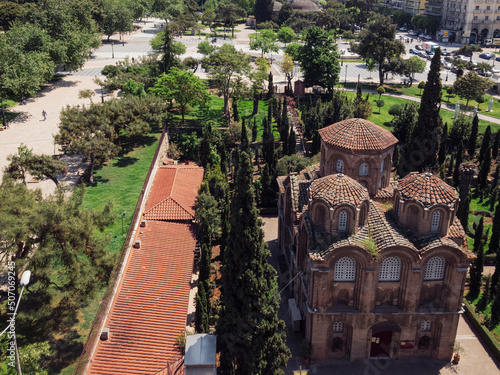 Greek Byzantine Orthodox church on a city square. Day elevated view of Thessaloniki Aristotelous square with park around 11th-century Panagia Chalkeon religious building. photo
