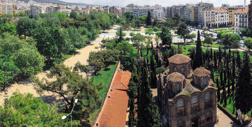 Greek Byzantine Orthodox church on a city square. Day elevated panorama view of Thessaloniki Aristotelous square with park around 11th-century Panagia Chalkeon religious building. photo