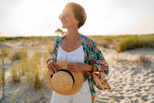 stylish attractive slim smiling woman on beach in summer style fashion trend outfit