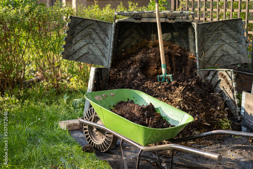 Foto Ready made compost soil in wheelbarrow for next use
