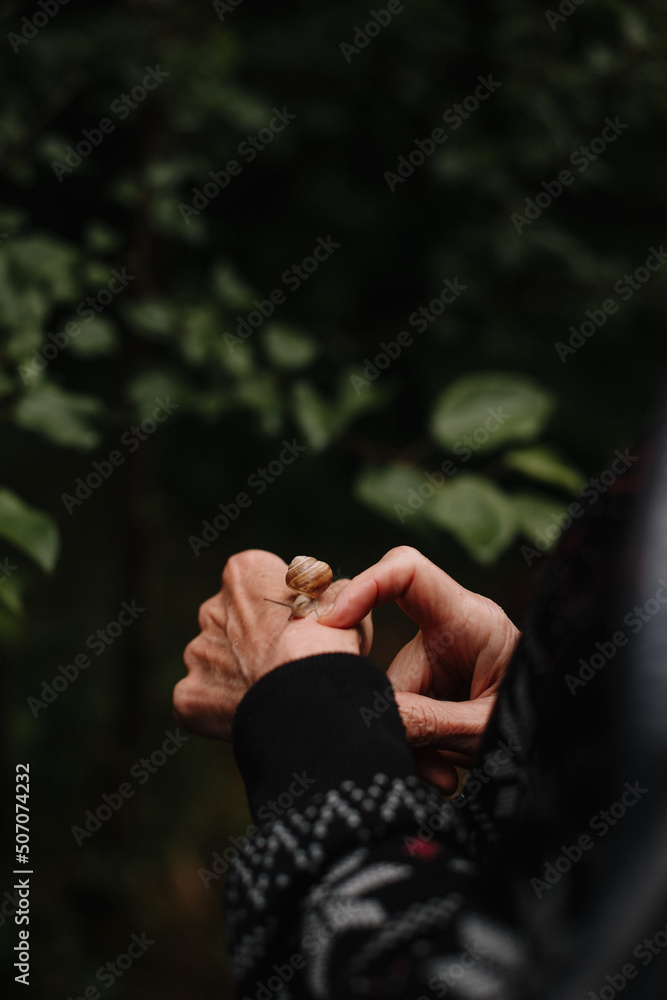 person in the forest with snail
