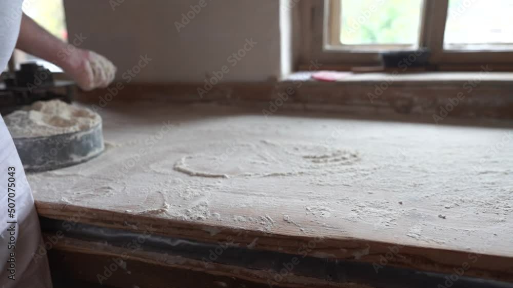 Baker throwing flour over the table Baker throwing flour over the table