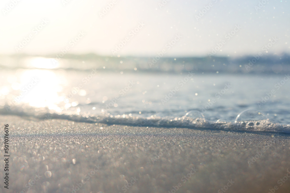 Fototapeta premium Sea waves and warm sunset light, calm and relaxing sandy beach