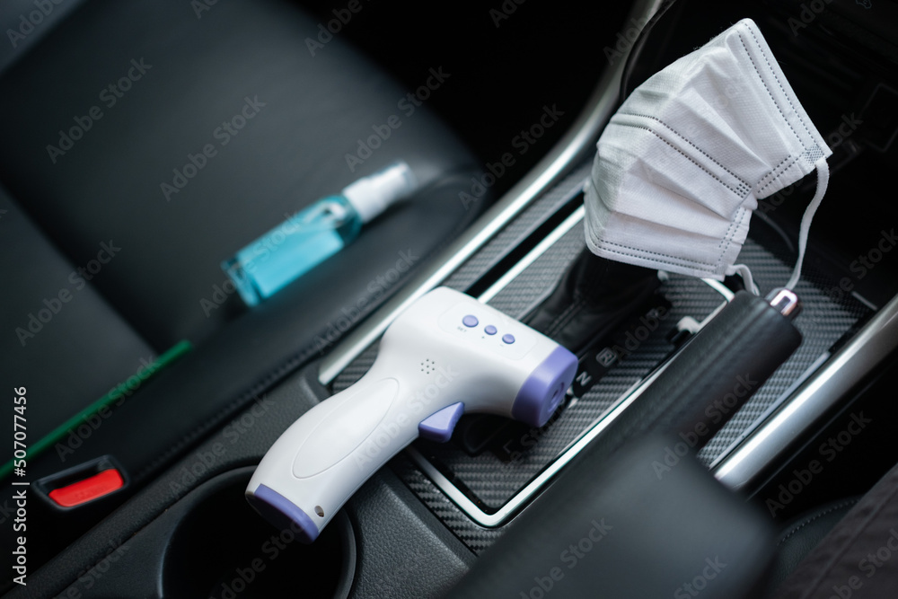digital Infrared thermometer and alcohol hand gel and protect mask on the car, concept for covid19
digital Infrared thermometer and alcohol hand gel and protect mask on the car, concept for covid19