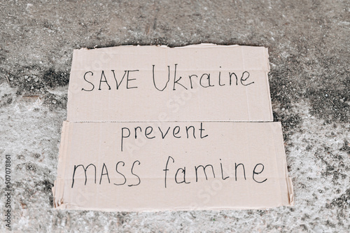 Save Ukraine is written on a piece of cardboard.