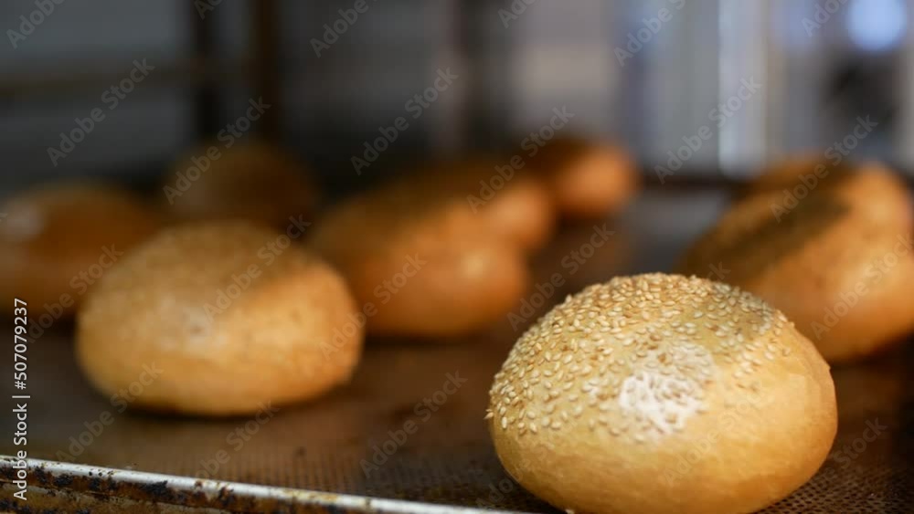 Bread bakery. Fresh buns sprinkled with sesame seeds close up Bread bakery. Fresh buns sprinkled with sesame seeds close up