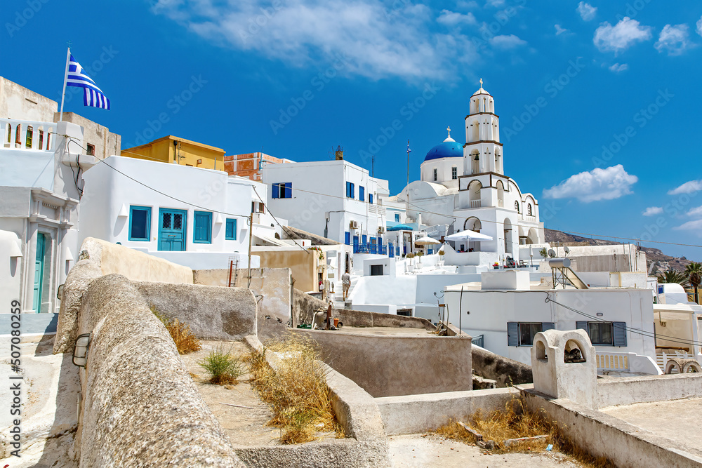 Fototapeta premium Walking through Santorini streets. Traditional Greek white houses architecture.