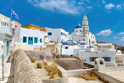 Fototapeta Naklejka Na Ścianę i Meble -  Walking through Santorini streets. Traditional Greek white houses architecture.