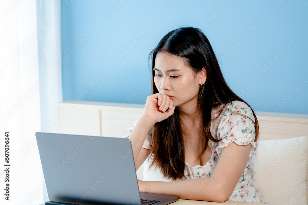 Asian woman shopping online on laptop He put his hands over his head and showed a worried expression because he couldn't buy the product in time. on bed in the bedroom online shopping ideas Asian woman shopping online on laptop He put his hands over his head and showed a worried expression because he couldn't buy the product in time. on bed in the bedroom online shopping ideas