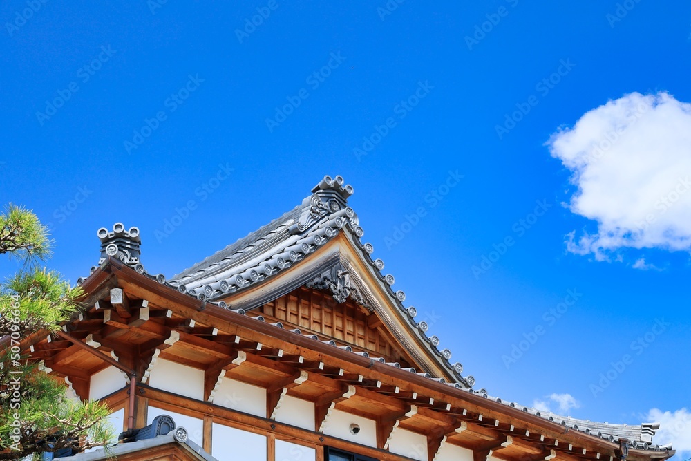 快晴の青空と古い建築物の風情ある瓦屋根