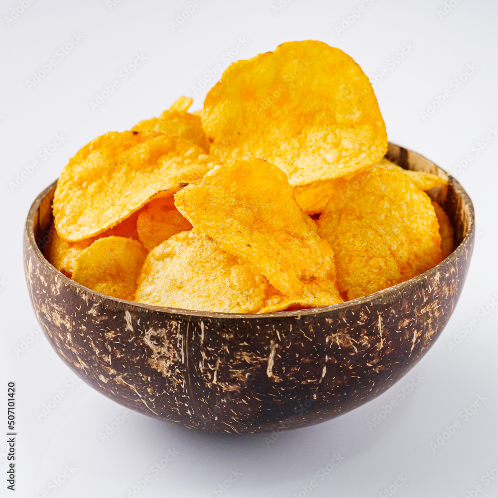golden crispy potato chips on a white background golden crispy potato chips on a white background