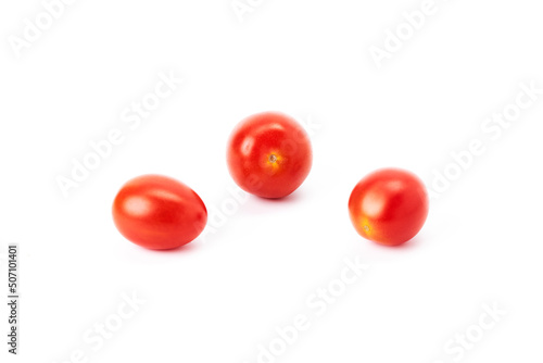 Three ripe red cherry tomatoes on a white background