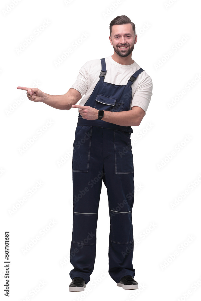 smiling man in overalls pointing to a copy of the space smiling man in overalls pointing to a copy of the space
