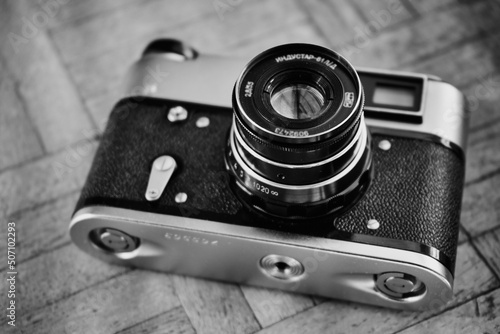 stary radziecki aparat na kliszę na drewnianej podłodze  photo