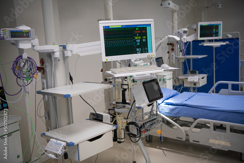 Empty Modern technology in intensive care unit room with different equipment and devices, beds and pillows.