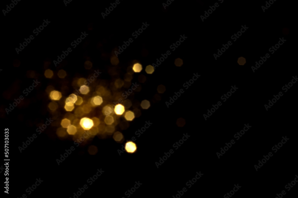 Golden blurred bokeh lights on black background. Glitter sparkle stars for celebrate. Overlay for your design Golden blurred bokeh lights on black background. Glitter sparkle stars for celebrate. Overlay for your design