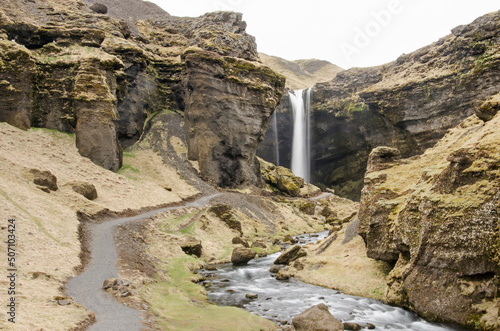 Kvernufoss waterfall, situated in a canyon with a path leading towards it, near Skogar in Iceland