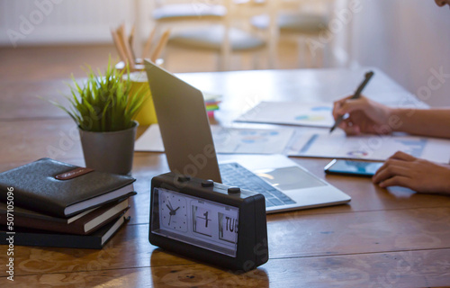 Wallpaper Mural Hand image of a business woman working in the morning warm light by computer notebook phone and chart sheets in business analysis Torontodigital.ca