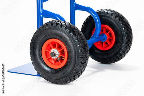 Wheels and platform of a blue cargo trolley, on the white background