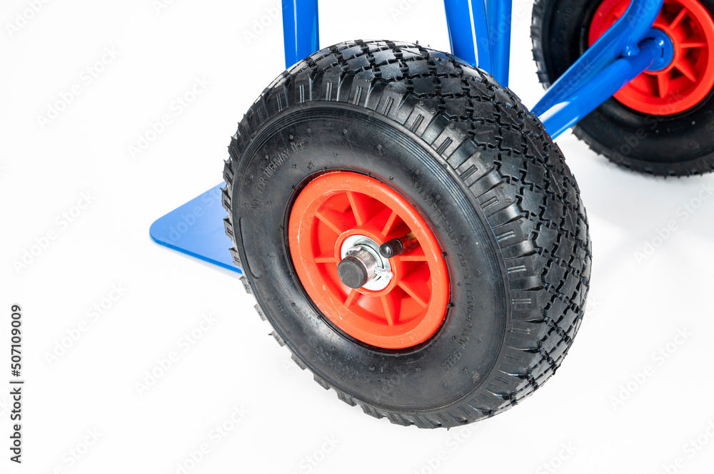 Fototapeta premium Wheels and platform of a blue cargo trolley, on the white background