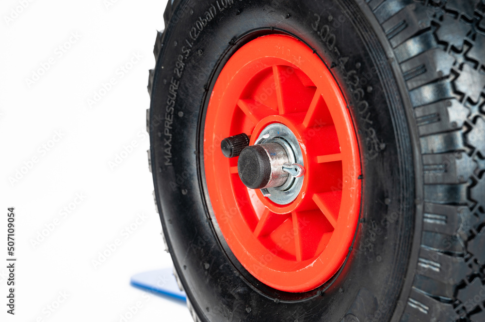 Wheels and platform of a blue cargo trolley, on the white background