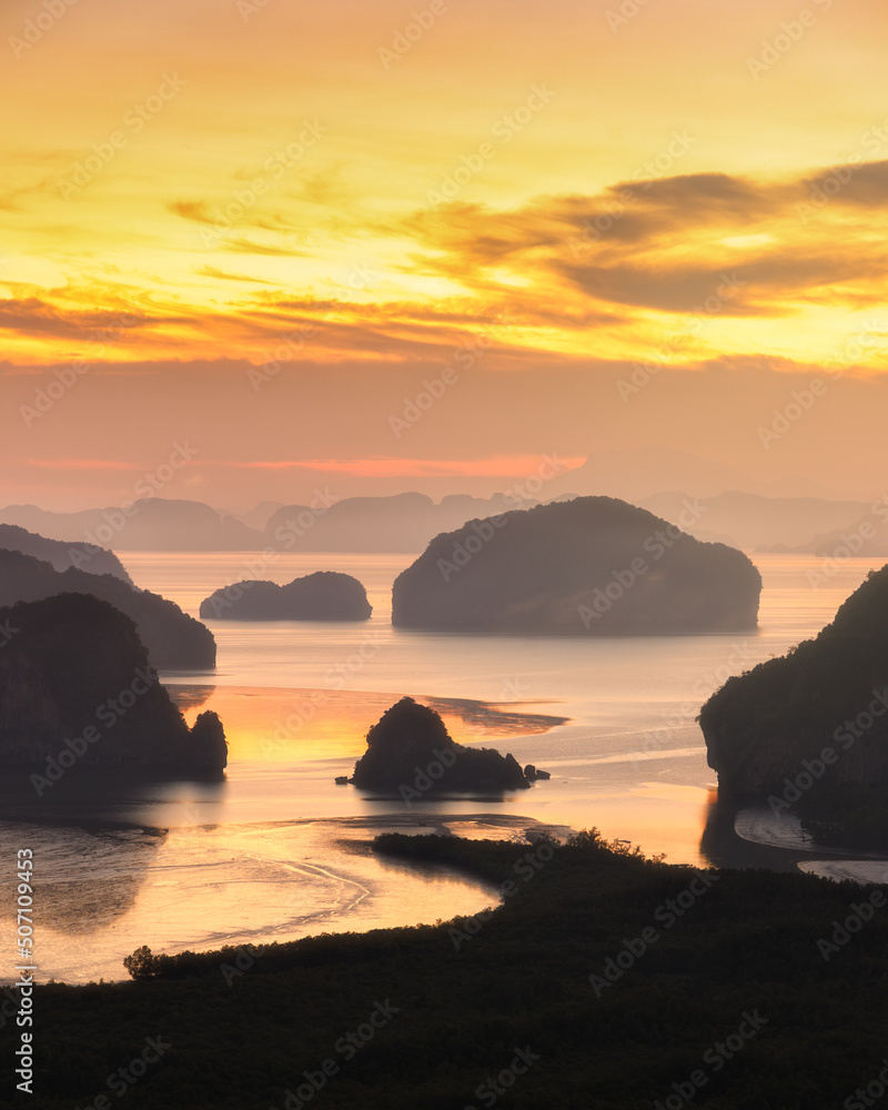 Sunrise at Samed Nang Chee viewpoint, Pang nga, Thailand. Seascape in morning with yellow and orange sky.