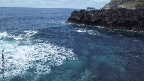 Flying over volcanic structures Lugar da Ferraria and the ocean southwest on San Miguel Island, Azores.