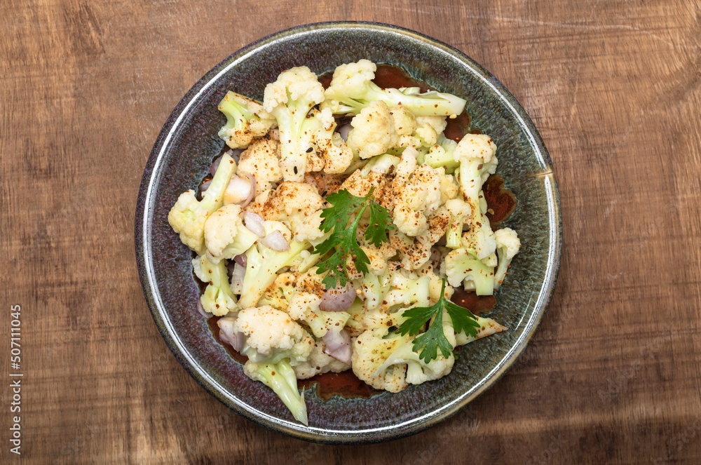 Healthy food cauliflower salad in bowl dish on wood background. Healthy food cauliflower salad in bowl dish on wood background.